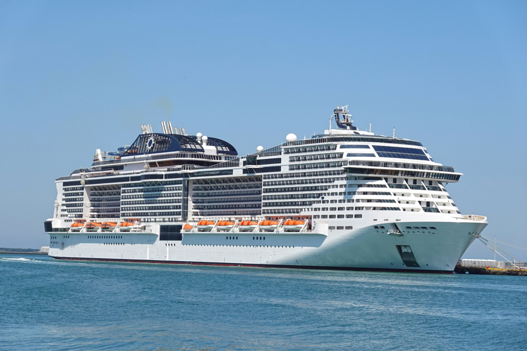 An ocean cruise liner navigating open waters, representing enclosed community viral transmission risks